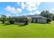 Expansive backyard with lush green lawn, screened-in patio, and solar panels at 6730 Sw 9Th Ave, Ocala, FL 34476