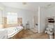 Bright bathroom featuring a soaking tub with tile surround and a separate shower stall at 6730 Sw 9Th Ave, Ocala, FL 34476