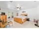 Large main bedroom with tile flooring, ceiling fan, and access to backyard at 6730 Sw 9Th Ave, Ocala, FL 34476