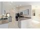 The kitchen has painted cabinets, appliances, tile floors, and open sight lines at 6730 Sw 9Th Ave, Ocala, FL 34476