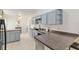 Cozy kitchen boasting painted cabinets, tile floors, and modern fixtures and appliances at 6730 Sw 9Th Ave, Ocala, FL 34476