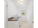 Laundry room with white appliances, counter space, storage and bright natural light at 6730 Sw 9Th Ave, Ocala, FL 34476