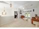 Open-concept living room featuring tiled floors, neutral paint, and access to the outdoor space through glass doors at 6730 Sw 9Th Ave, Ocala, FL 34476