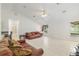 Bright living room features tile floors, ceiling fan, and a large window with lots of light at 6730 Sw 9Th Ave, Ocala, FL 34476