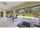 Screened-in porch area features a bar table and overlooks the backyard at 6730 Sw 9Th Ave, Ocala, FL 34476