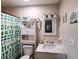 Bathroom featuring a vanity with marble countertop and decorative cactus-themed shower curtain at 6814 Se 53Rd Pl, Ocala, FL 34472