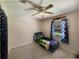 Bedroom featuring neutral walls, a ceiling fan, and a large window allowing natural light at 6814 Se 53Rd Pl, Ocala, FL 34472