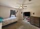 Bedroom with carpet, ceiling fan, tv, bed, dresser, and window providing natural light at 6814 Se 53Rd Pl, Ocala, FL 34472