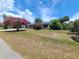 View of a single-story home with a spacious front yard and landscaping, offering curb appeal at 6814 Se 53Rd Pl, Ocala, FL 34472