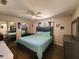Comfortable main bedroom with a ceiling fan, and plenty of space for relaxation at 6814 Se 53Rd Pl, Ocala, FL 34472