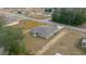 An aerial view of a single story home featuring a gray roof and neutral colored siding surrounded by an ample yard at 7 Dogwood Trail Run, Ocala, FL 34472