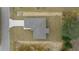 Birds eye view of a single story home with a gray roof, set on a large lot next to a paved street at 7 Dogwood Trail Run, Ocala, FL 34472