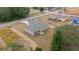 A high angle view of a single story home featuring a neutral color scheme and concrete driveway in a suburban setting at 7 Dogwood Trail Run, Ocala, FL 34472