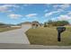Single-story home with a long driveway, an attached two-car garage, and a well-maintained lawn at 7 Dogwood Trail Run, Ocala, FL 34472