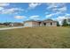Single-story home with a long driveway, an attached two-car garage, and a well-maintained lawn at 7 Dogwood Trail Run, Ocala, FL 34472