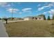 Single-story home with a long driveway, an attached two-car garage, and a well-maintained lawn at 7 Dogwood Trail Run, Ocala, FL 34472