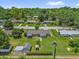 This aerial view shows a large yard, mature trees, a utility pole, and neighborhood residences at 713 Se 34Th Ter, Ocala, FL 34471