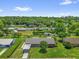Aerial view of a home with a long driveway, mature trees, and a large grassy backyard at 713 Se 34Th Ter, Ocala, FL 34471