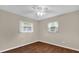 This bedroom has hardwood floors, neutral walls and two windows at 713 Se 34Th Ter, Ocala, FL 34471