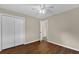 This bedroom has hardwood floors, neutral walls and an open doorway at 713 Se 34Th Ter, Ocala, FL 34471