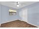This bedroom has hardwood floors and light blue walls at 713 Se 34Th Ter, Ocala, FL 34471