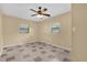 Bedroom with two windows and neutral walls, showing potential for a comfortable and personalized space at 713 Se 34Th Ter, Ocala, FL 34471