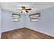 This bedroom has hardwood floors, light blue walls and two windows at 713 Se 34Th Ter, Ocala, FL 34471