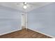 This bedroom has hardwood floors, light blue walls and an open doorway at 713 Se 34Th Ter, Ocala, FL 34471