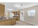 Functional kitchen with light wood cabinets, tile countertops, and adjacent pantry space at 713 Se 34Th Ter, Ocala, FL 34471