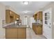 Functional kitchen boasts light wood cabinetry, tile flooring, and an open layout at 713 Se 34Th Ter, Ocala, FL 34471