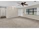 Bright living room features carpeted floors, ceiling fan, large window, and ample space for comfortable living at 713 Se 34Th Ter, Ocala, FL 34471