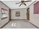 This sunroom has tile flooring, windows, a ceiling fan, and painted walls with molding and access to an exterior door at 713 Se 34Th Ter, Ocala, FL 34471