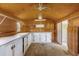 The shed interior features plywood walls, built-in shelving, a window, and white cabinetry with a back door entrance at 713 Se 34Th Ter, Ocala, FL 34471