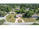 Aerial view of a home showcasing its landscaped yard, driveway, and surrounding neighborhood at 7443 Sw 102Nd Pl, Ocala, FL 34476