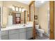 Well-lit bathroom featuring a vanity, decorative mirrors, and a glass-enclosed shower stall at 7443 Sw 102Nd Pl, Ocala, FL 34476