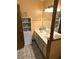 Well-lit bathroom with double vanity, tile floors, and storage shelves for a functional design at 7443 Sw 102Nd Pl, Ocala, FL 34476