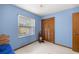 Bright bedroom offers a closet, a window with natural light, and a neutral carpet at 7443 Sw 102Nd Pl, Ocala, FL 34476