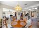 Open-concept dining area with views into the living room and kitchen at 7443 Sw 102Nd Pl, Ocala, FL 34476