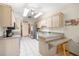 Bright kitchen with stainless steel appliances, tile flooring, and a breakfast bar at 7443 Sw 102Nd Pl, Ocala, FL 34476