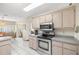 Modern kitchen featuring stainless steel appliances, white cabinets, and tile flooring at 7443 Sw 102Nd Pl, Ocala, FL 34476