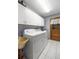 Functional laundry room with front load washer and dryer and overhead storage cabinets at 7443 Sw 102Nd Pl, Ocala, FL 34476