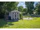Backyard shed on a lush lawn, perfect for extra storage at 7443 Sw 102Nd Pl, Ocala, FL 34476