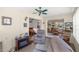 Bright sunroom features a cozy seating area, indoor fireplace, and views of the adjacent rooms at 7443 Sw 102Nd Pl, Ocala, FL 34476