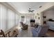 Relaxing sun room with tiled floor, ceiling fan, large windows, and comfortable seating at 7443 Sw 102Nd Pl, Ocala, FL 34476