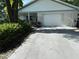Charming single-story home featuring a light brick facade, attached garage, and well-maintained landscaping at 8874 Sw 95Th St # B, Ocala, FL 34481