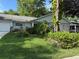 Landscaped front yard with lush greenery and a charming single-story home featuring a light brick facade at 8874 Sw 95Th St # B, Ocala, FL 34481