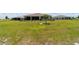 This home's backyard is spacious with a water feature, mature landscaping, and a view of the rear of the home at 9746 Sw 108Th Terrace Rd, Ocala, FL 34481