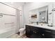 Bright bathroom features a shower-tub combo with black fixtures and a sleek vanity with a quartz countertop at 9746 Sw 108Th Terrace Rd, Ocala, FL 34481