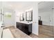 Bathroom featuring a dual sink vanity with black hardware and wood look flooring at 9746 Sw 108Th Terrace Rd, Ocala, FL 34481