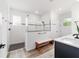 Modern bathroom featuring a glass enclosed shower, bench and wood look flooring at 9746 Sw 108Th Terrace Rd, Ocala, FL 34481